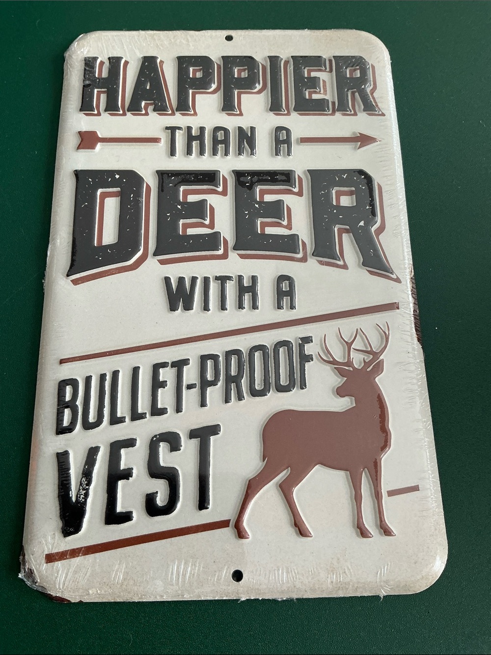 Happier Than A Deer With A Bullet Proof Vest Embossed Metal Sign